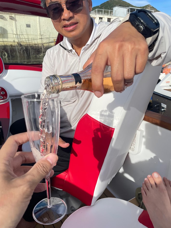 Champagne being poured for guests aboard a private Goofy Waves trip